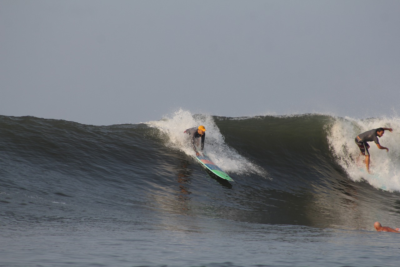 Bitcoin Beach, surfers over a wave