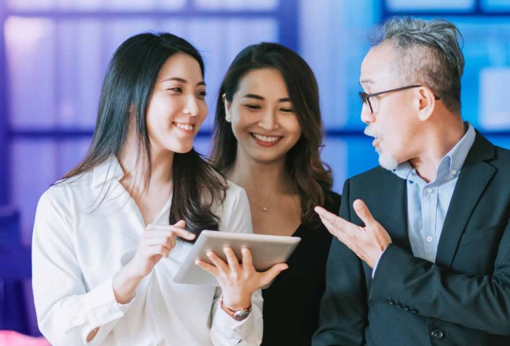 Singapore, two asian woman and a man in work attire